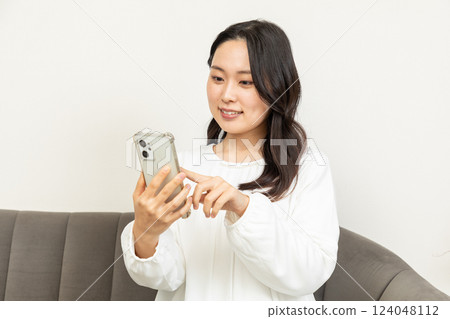 Asian woman checking on smartphone 08 124048112