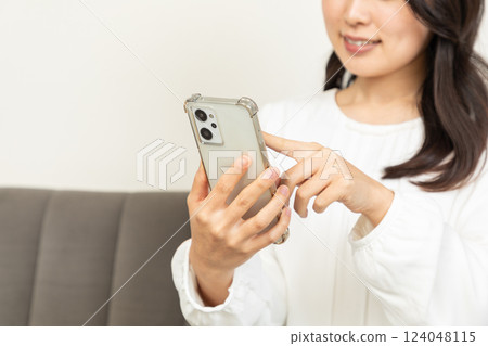 Asian woman checking on smartphone 05 124048115