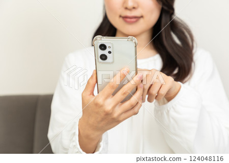 Asian woman checking on smartphone 03 Asian woman checking on smartphone 03 124048116