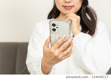 Asian woman checking on smartphone 02 Asian woman checking on smartphone 02 124048117