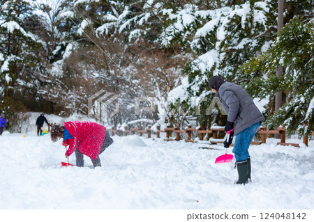 一對夫婦在雪地裡玩耍 124048142