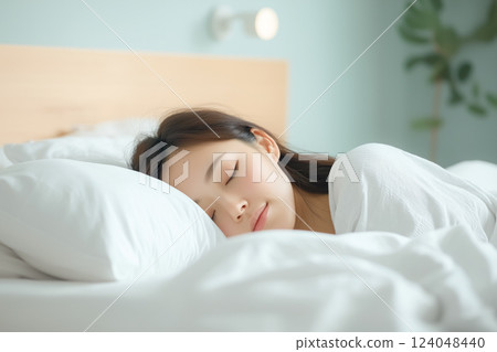 Cozy tranquil bedroom scene with a woman sleeping peacefully 124048440