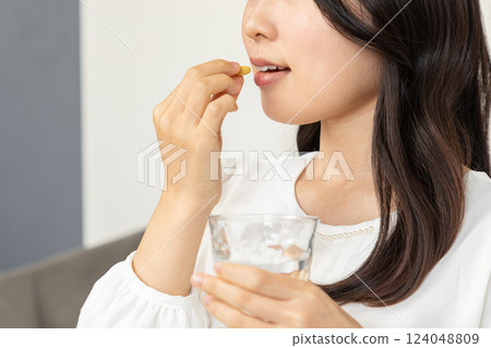 Asian woman taking medicine 01 124048809