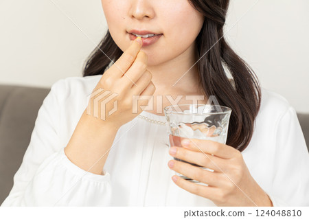 Asian woman taking medicine 02 Asian woman taking medicine 02 124048810