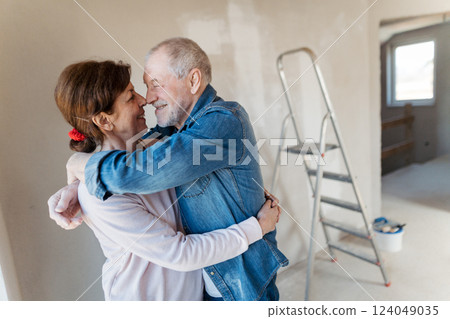 Senior couple renovating their home, a shared retirement activity. Senior couple renovating their home, a shared retirement activity. 124049035