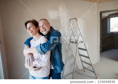 Senior couple renovating their home, a shared retirement activity. Senior couple renovating their home, a shared retirement activity. 124049036