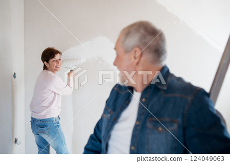 Senior couple renovating their home, a shared retirement activity. 124049063