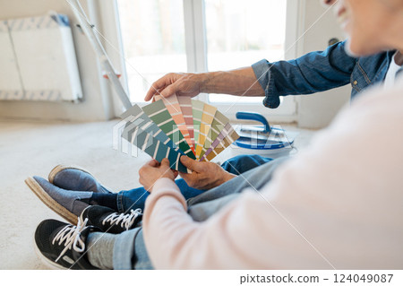 Couple choosing paint colors for their home renovation project. 124049087