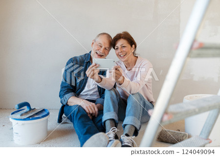 Senior couple taking break during their home renovation, taking a selfie. Senior couple taking break during their home renovation, taking a selfie. 124049094