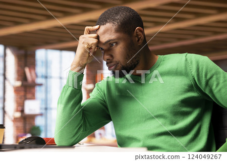 Frustrated remote worker at home office desk browsing internet on notebook feeling bored while researching information online. Annoyed student tired of reading articles for school tasks Frustrated remote worker at home office desk browsing internet on notebook feeling bored while researching information online. Annoyed student tired of reading articles for school tasks 124049267