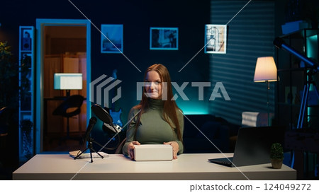 Content creator filming technology review of various electronics, unboxing them and presenting features to audience. Influencer showing product recommendations to followers on social media, camera B 124049272