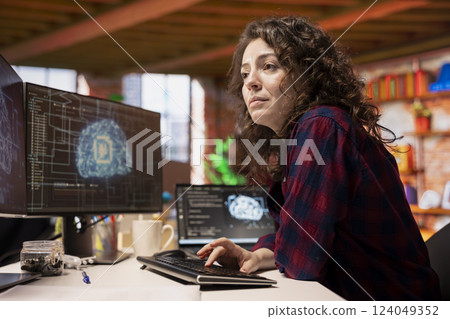 System administrator in startup office coding advanced AI algorithm and machine learning models enhancing automation. IT specialist using PC in artificial intelligence Silicon Valley workplace 124049352