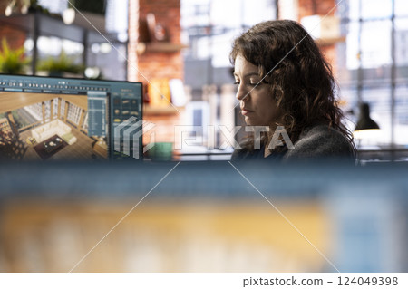 Young woman editor uses digital interface to design an apartment floor plan, working on a 3D modeling project. Architectural software enables professional rendering and virtual home configuration. Young woman editor uses digital interface to design an apartment floor plan, working on a 3D modeling project. Architectural software enables professional rendering and virtual home configuration. 124049398