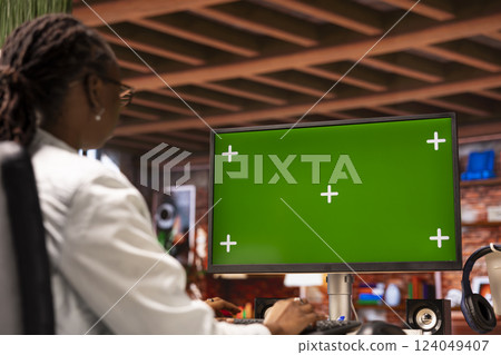 Woman inputting data on chroma key PC, completing spreadsheets in home office. African american person editing documents on isolated screen computer, updating reports and files 124049407
