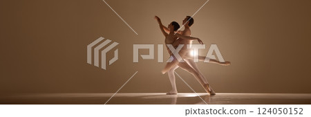 Banner. Ballet duet entwined in expressive pose, intimacy and strength captured in warm glow, feet on pointe, bodies aligned in motion. 124050152