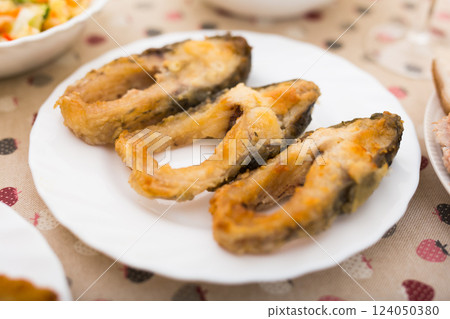 Three pieces of fried carp on a white plate Three pieces of fried carp on a white plate 124050380