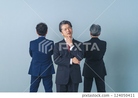 A group of middle-aged male business people having trouble with relationships A group of middle-aged male business people having trouble with relationships 124050411
