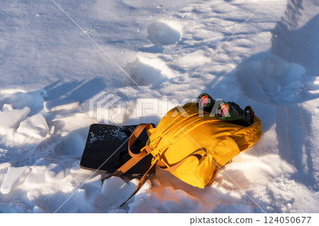 Yellow backpack and binoculars lying on the snow Ecotourism and birdwatching concept Yellow backpack and binoculars lying on the snow Ecotourism and birdwatching concept 124050677