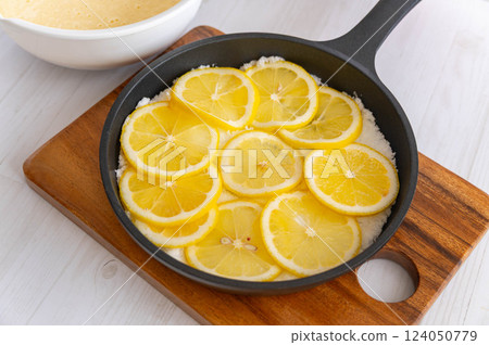 Spread sugar in a skillet and top with lemon slices. Spread sugar in a skillet and top with lemon slices. 124050779