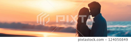 A couple sharing a tender moment on a beach, representing love and romance, with a beautiful sunset in the background and a gentle ocean breeze A couple sharing a tender moment on a beach, representing love and romance, with a beautiful sunset in the background and a gentle ocean breeze 124050849