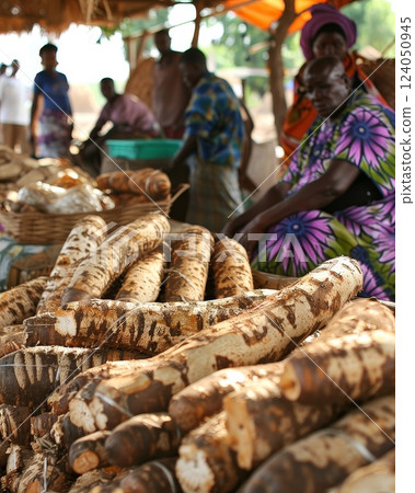 An image depicting a traditional African market with cassava roots being sold, showcasing the role of cassava as a cash crop and a key ingredient in ethnic food and culinary traditions 124050945