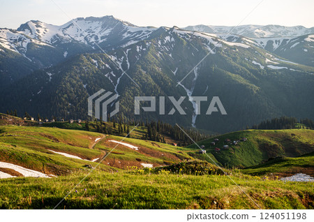 Mountain landscape with blooming plants, sunrise or sunset and valley in the background. Mountain landscape with blooming plants, sunrise or sunset and valley in the background. 124051198
