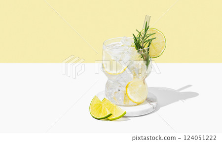 Cocktail mojito with lime, lemon, rosemary and ice in a glass on a white yellow background Cocktail mojito with lime, lemon, rosemary and ice in a glass on a white yellow background 124051222
