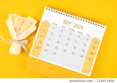 September 2025 desk calendar with bouquet flower on yellow background. 124051490