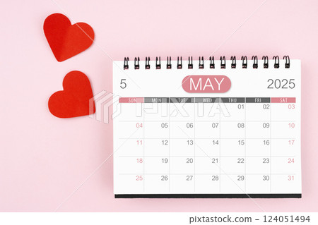 Red heart with May 2025 desk calendar on pink background. Red heart with May 2025 desk calendar on pink background. 124051494