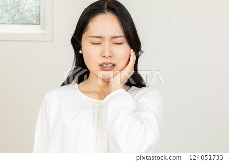 Asian woman having toothache 01 Asian woman having toothache 01 124051733