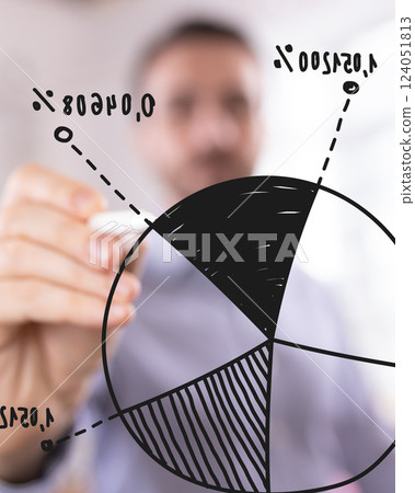 Business analyst drawing pie chart on transparent board, visualizing data-driven decision-making in corporate environment 124051813