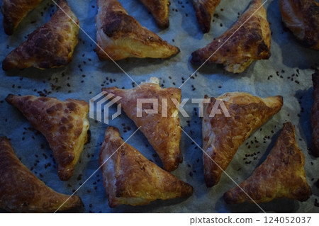 Flaky Triangular Pastries with Sesame Seeds Flaky Triangular Pastries with Sesame Seeds 124052037