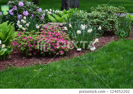 A well-maintained garden with various plants and flowers. Purple and White Flourish 124052202