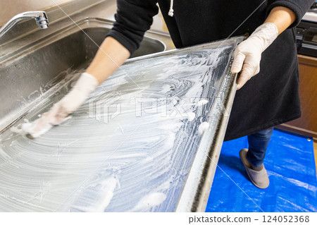 The hands of a person removing a glass window and washing it with detergent The hands of a person removing a glass window and washing it with detergent 124052368