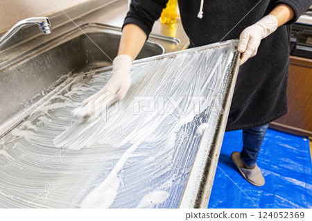 The hands of a person removing a glass window and washing it with detergent The hands of a person removing a glass window and washing it with detergent 124052369