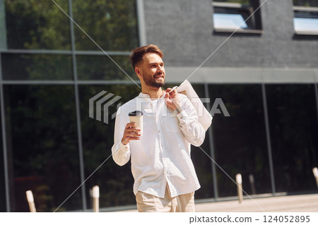 Cheerful mood. Stylish young man have shopping day. Outdoors with bags Cheerful mood. Stylish young man have shopping day. Outdoors with bags 124052895