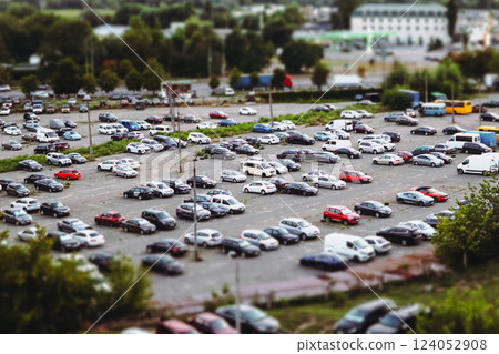 Huge parking lot with many cars in a big city aerial view. Transportation and transport modes in an urban environment. A parking lot for vehicles Huge parking lot with many cars in a big city aerial view. Transportation and transport modes in an urban environment. A parking lot for vehicles 124052908
