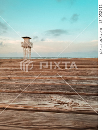 A white wooden lifeguard watchtower located on the beach. A rescue station on the ocean coast in the morning. Empty coastline. Summer holidays on sea 124052911