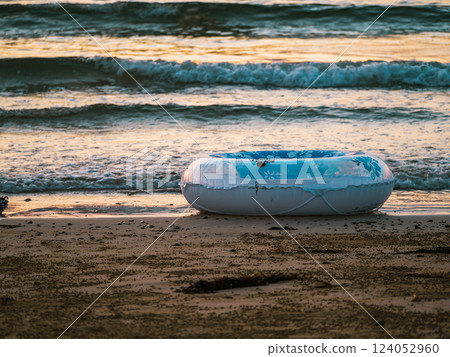 A floating ring abandoned on the beach 124052960