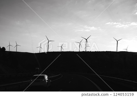Wind turbines energy generator on wind farm black and white background. Natural renewable green energy. Future technologies. Harnessing wind power. Wind turbines energy generator on wind farm black and white background. Natural renewable green energy. Future technologies. Harnessing wind power. 124053159
