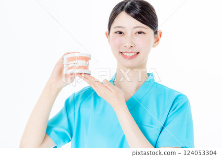 Dental hygienist with toothbrush 124053304