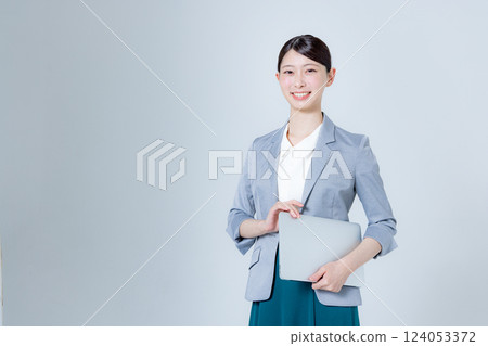A female business person giving directions with a laptop A female business person giving directions with a laptop 124053372