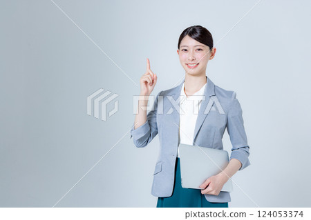 A female business person giving directions with a laptop 124053374