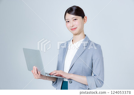 A female business person giving directions with a laptop 124053378