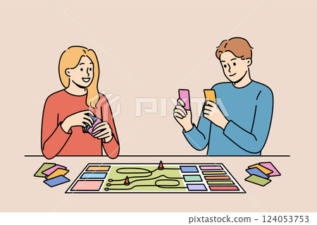 Happy couple playing board game while spending free time together and having fun after working day 124053753