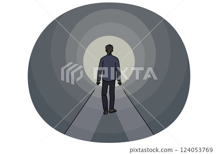 Man walks through tunnel towards exit, striving to achieve success and get out problematic situation Man walks through tunnel towards exit, striving to achieve success and get out problematic situation 124053769