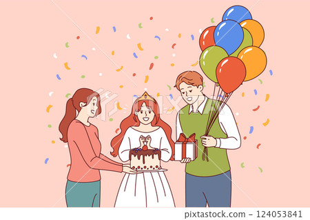 Birthday of little princess standing next to mom and dad holding cake and gift with balloons 124053841