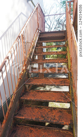 Rusty and dilapidated steel exterior stairs 124054086
