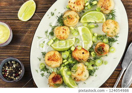 Seared scallops on a plate. 124054986
