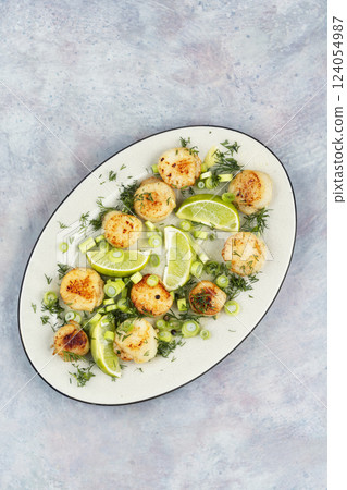 Delicious scallops with sauce. 124054987